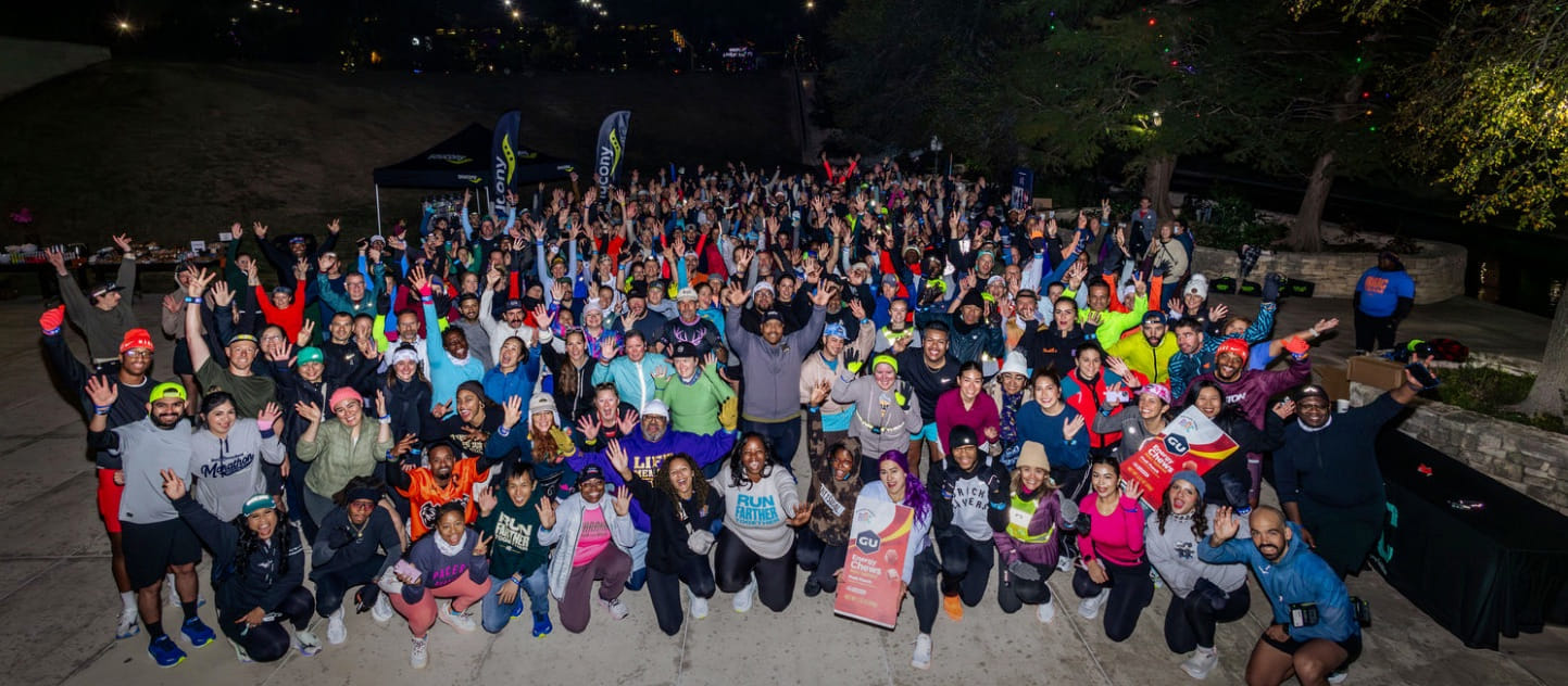 Running community group photo at a night run event